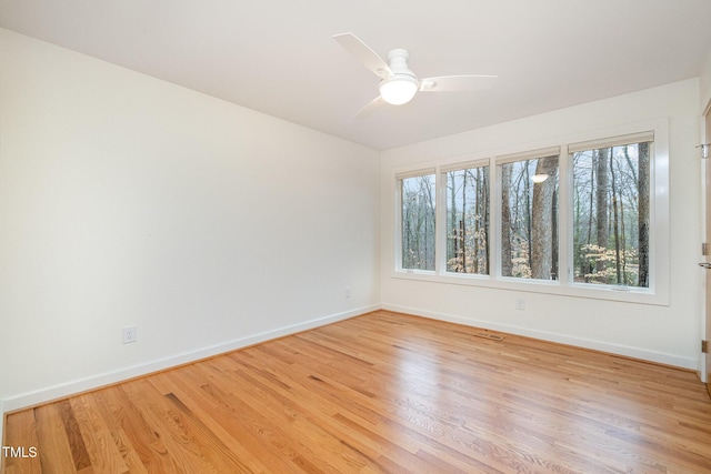 spare room featuring light hardwood / wood-style floors and ceiling fan