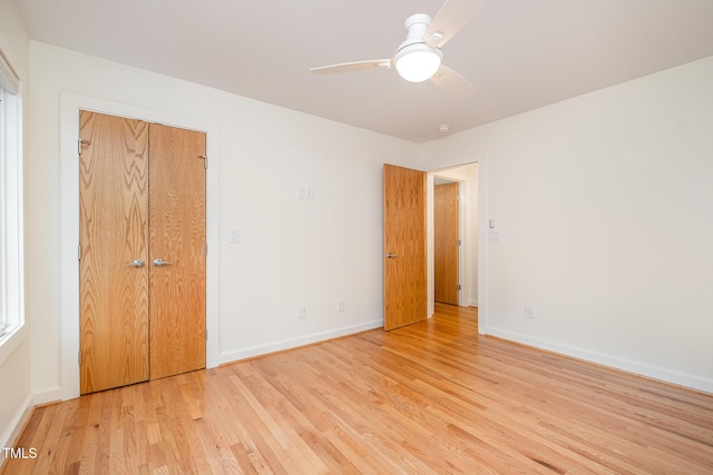 unfurnished bedroom with ceiling fan, light hardwood / wood-style flooring, and a closet