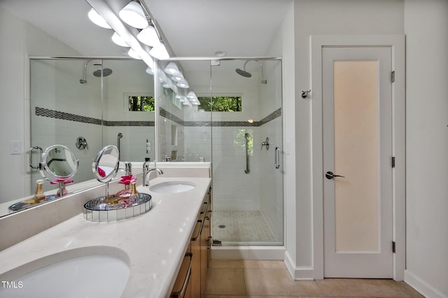 bathroom with tile patterned flooring, vanity, and a shower with shower door