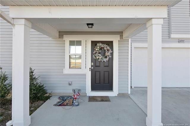 doorway to property with a garage