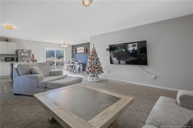 living room with an inviting chandelier and dark carpet