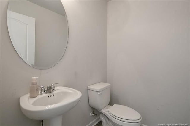 bathroom featuring sink and toilet