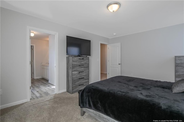 carpeted bedroom featuring ensuite bath