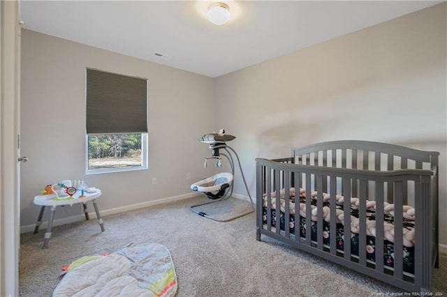 bedroom featuring carpet and a crib