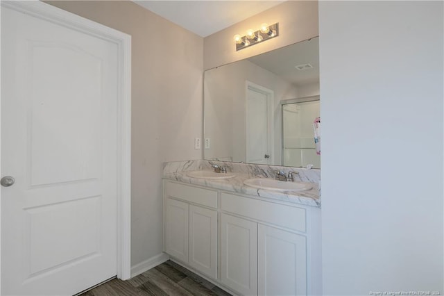 bathroom with hardwood / wood-style floors and vanity