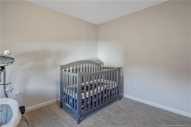 bedroom with carpet and a nursery area