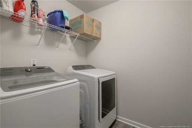 washroom featuring washer and clothes dryer and hardwood / wood-style floors