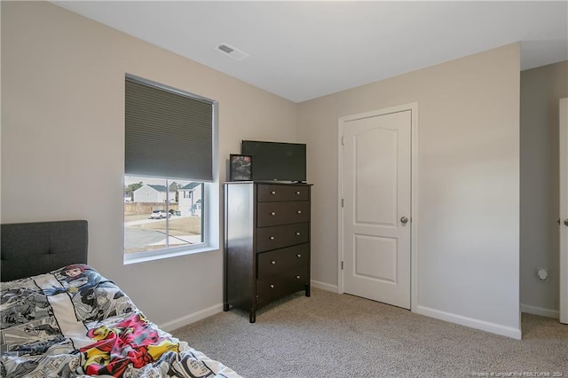 bedroom featuring light carpet