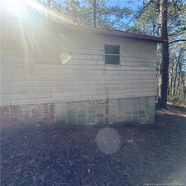 view of side of home featuring crawl space