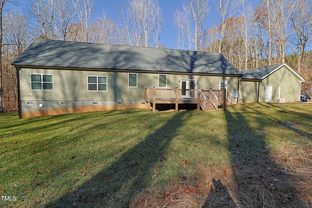 rear view of house featuring a yard and a wooden deck