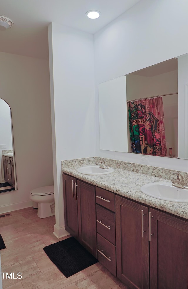 bathroom featuring vanity and toilet