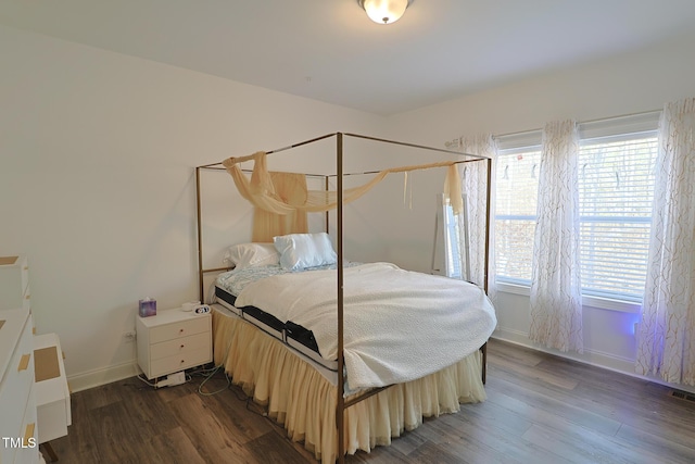 bedroom with dark hardwood / wood-style floors