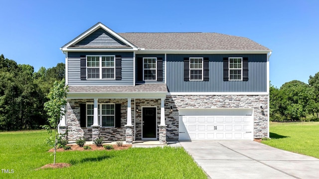 view of front facade featuring a front yard and a garage