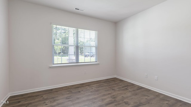 empty room featuring dark wood-type flooring