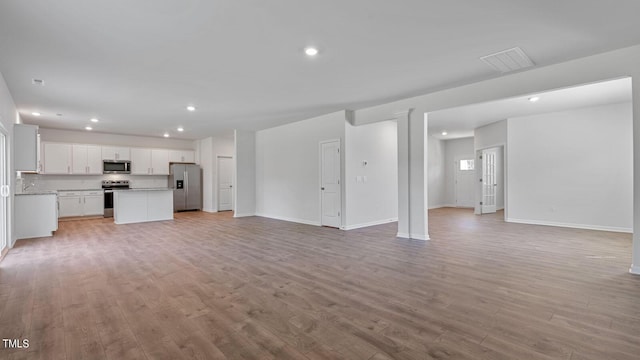 unfurnished living room featuring light wood-type flooring