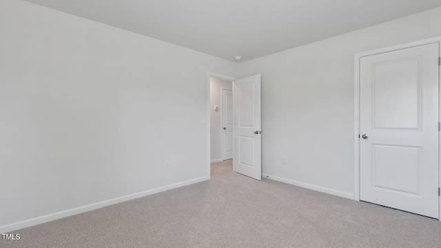 spare room with light colored carpet