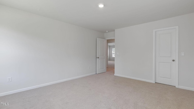 empty room featuring light colored carpet