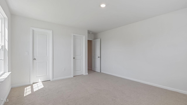 unfurnished bedroom with light carpet