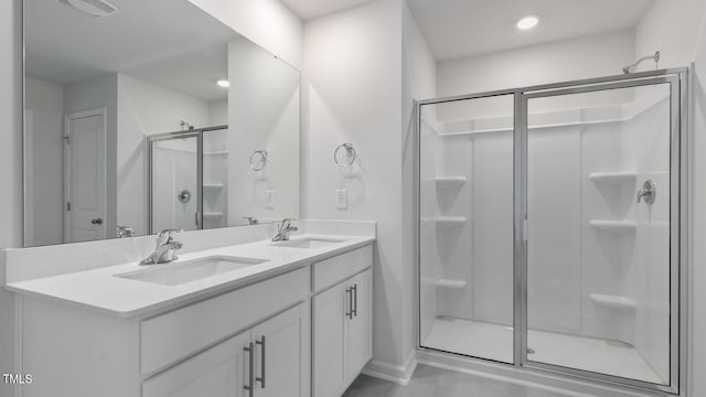 bathroom with vanity and a shower with shower door