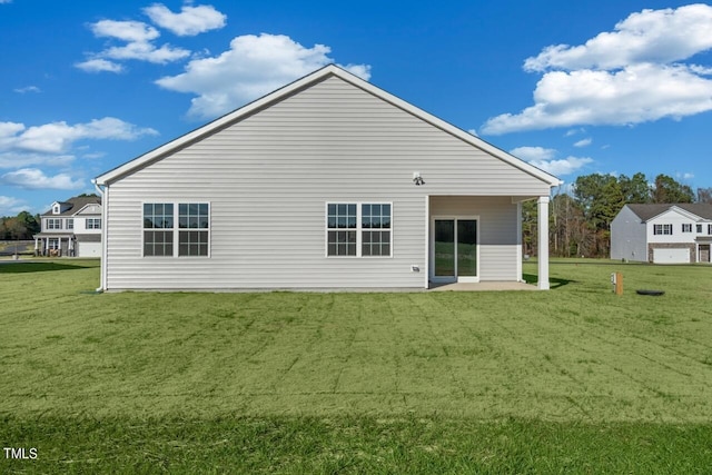 back of property featuring a lawn