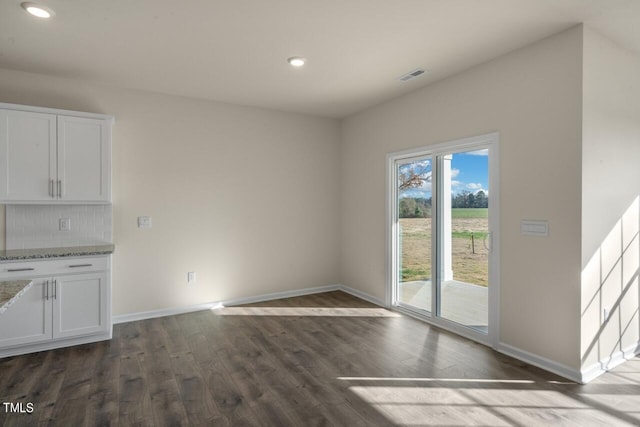 unfurnished dining area with dark hardwood / wood-style flooring