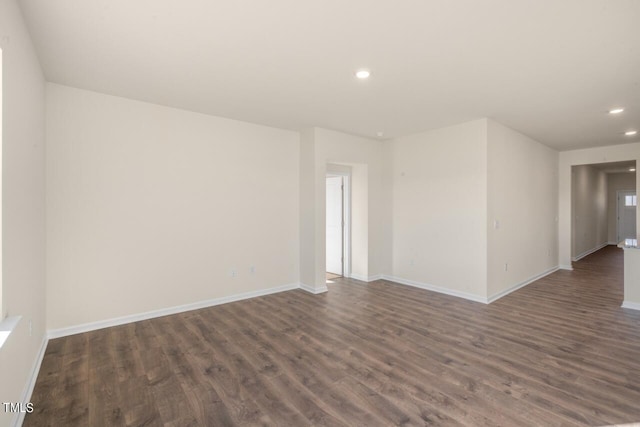 empty room featuring dark hardwood / wood-style flooring