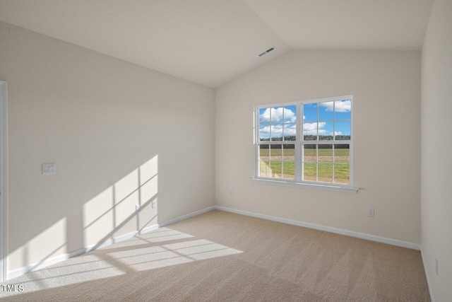 empty room with light carpet and vaulted ceiling