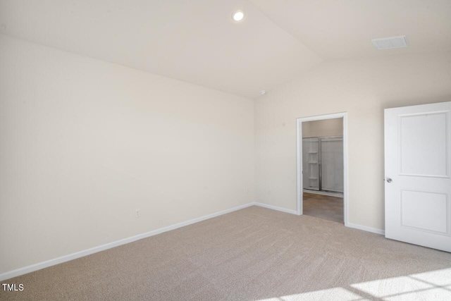 unfurnished bedroom with light carpet and lofted ceiling