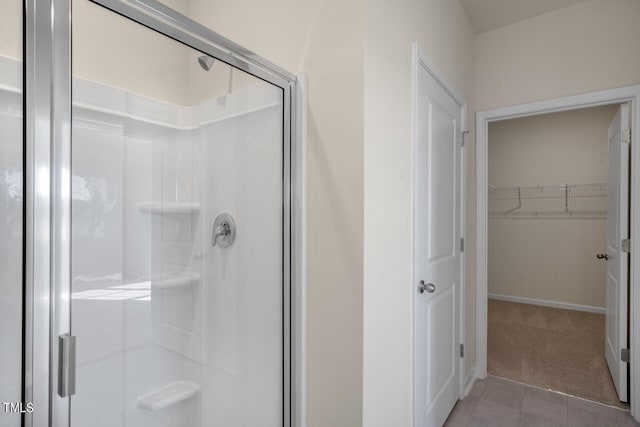 bathroom featuring a shower with shower door