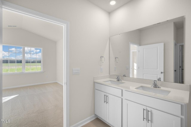 bathroom featuring vanity and lofted ceiling