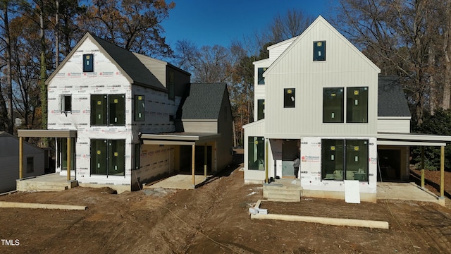 rear view of property with a garage