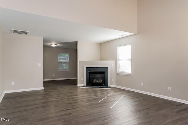 unfurnished living room featuring dark hardwood / wood-style flooring