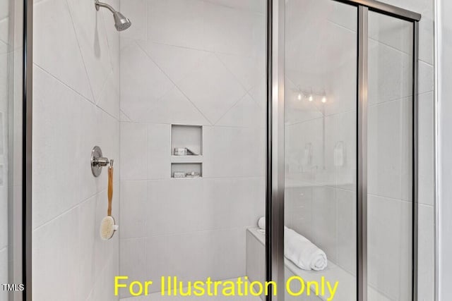 bathroom featuring a shower with door