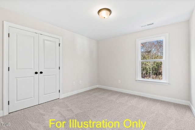 unfurnished bedroom with light colored carpet and a closet