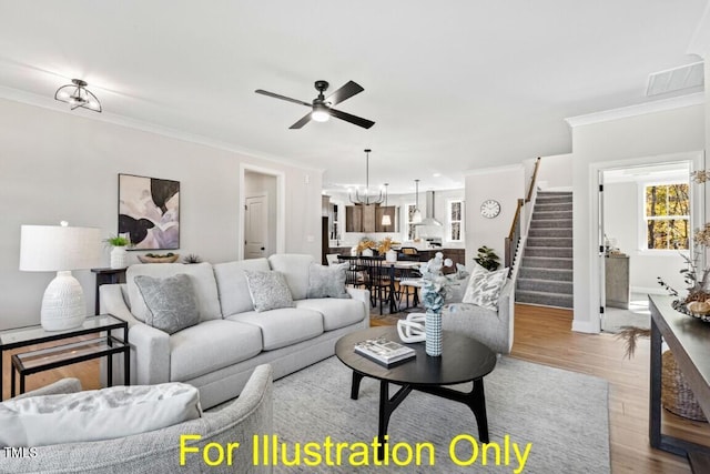 212 Rawhide Dr, Louisburg, NC 27549 - living area with stairway, ceiling fan, crown molding, wood finished floors, and a chandelier