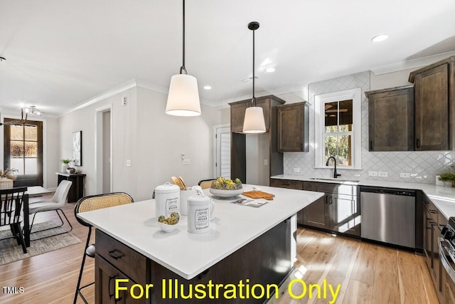 kitchen featuring pendant lighting, sink, a breakfast bar area, light hardwood / wood-style floors, and stainless steel appliances