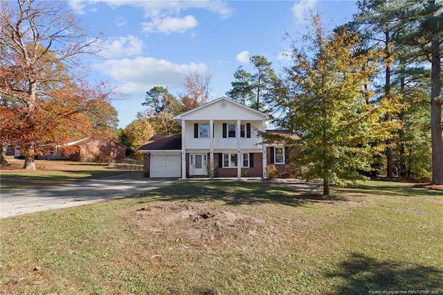 view of front facade featuring a garage and a front lawn