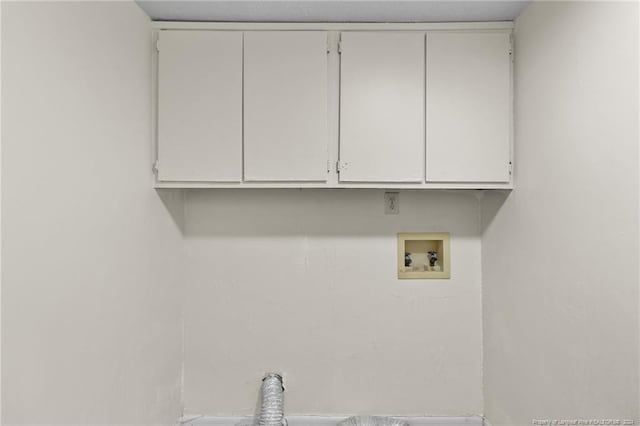 clothes washing area featuring cabinets and hookup for a washing machine