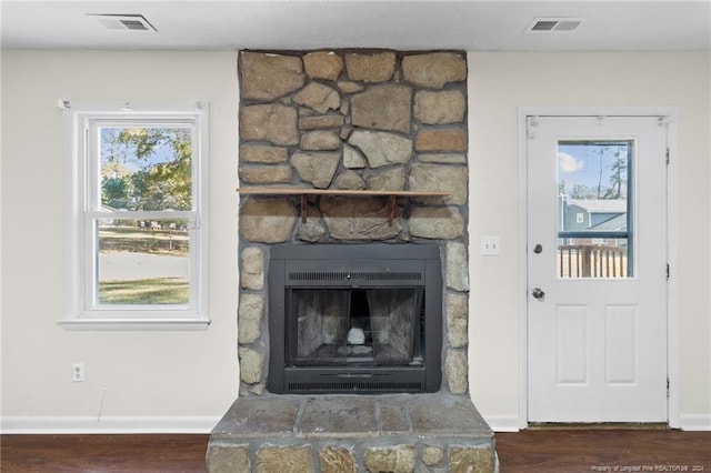 details with hardwood / wood-style flooring and a fireplace