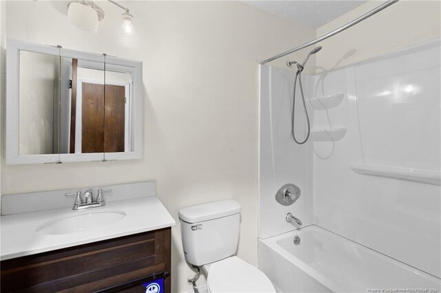 full bathroom featuring toilet, vanity, and tub / shower combination