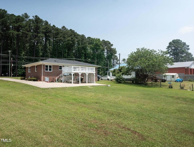 back of property with a yard and a deck