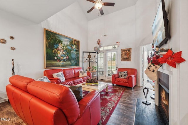 living room with high vaulted ceiling, ceiling fan, and dark hardwood / wood-style flooring