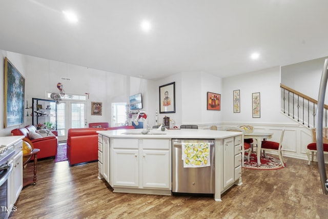 kitchen featuring stainless steel appliances, a center island with sink, white cabinetry, and sink