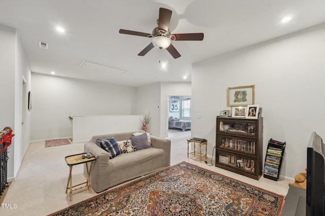 living room featuring light carpet and ceiling fan