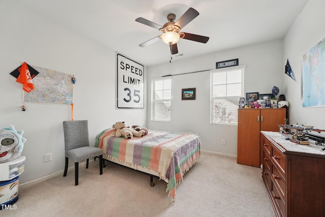 bedroom with ceiling fan and light carpet