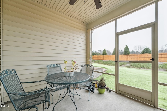 sunroom / solarium featuring ceiling fan