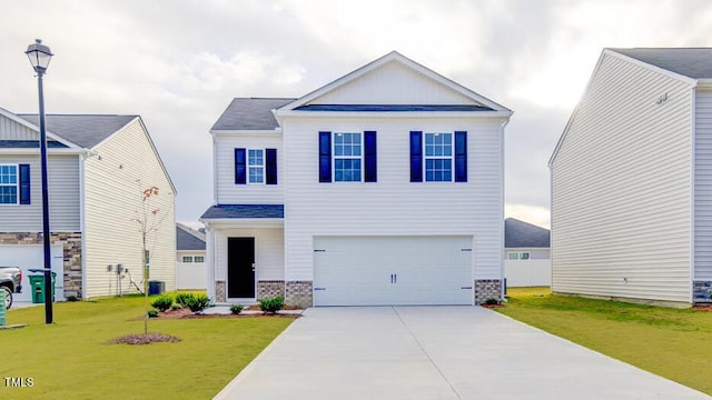 view of front of house featuring a front yard and a garage