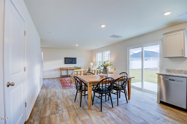 dining space featuring a mountain view and light hardwood / wood-style floors