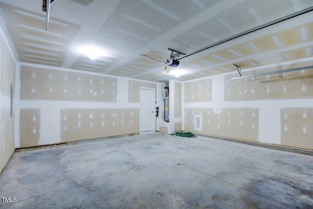 garage featuring electric water heater and a garage door opener