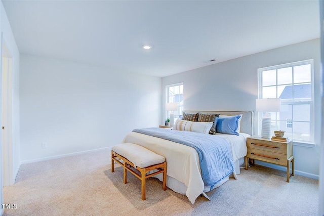 carpeted bedroom with multiple windows